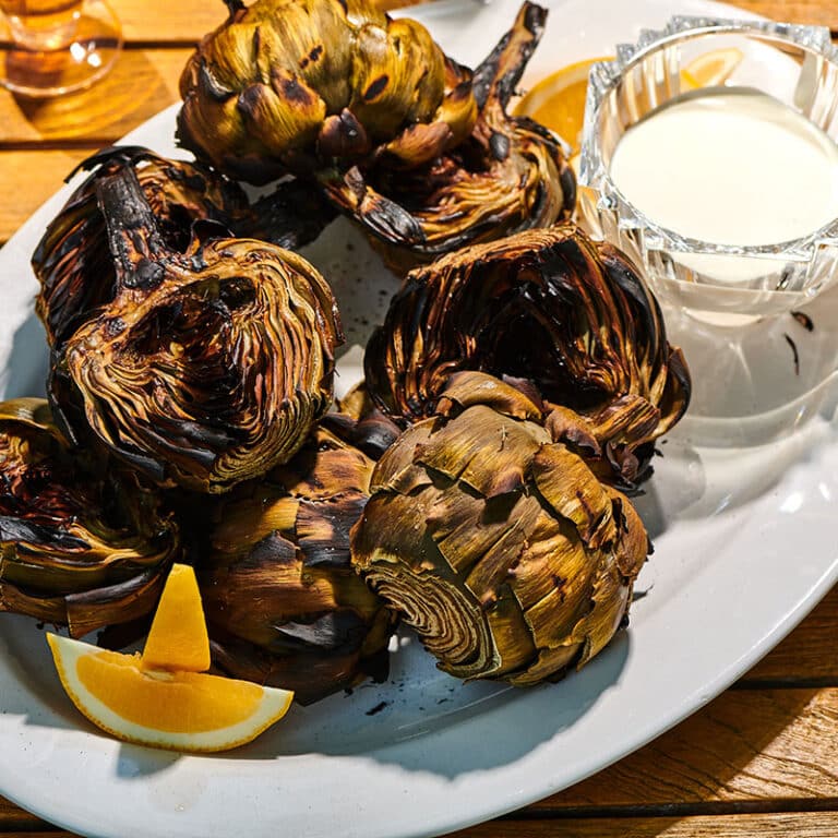 Grilled Artichokes with lemon sauce on plate