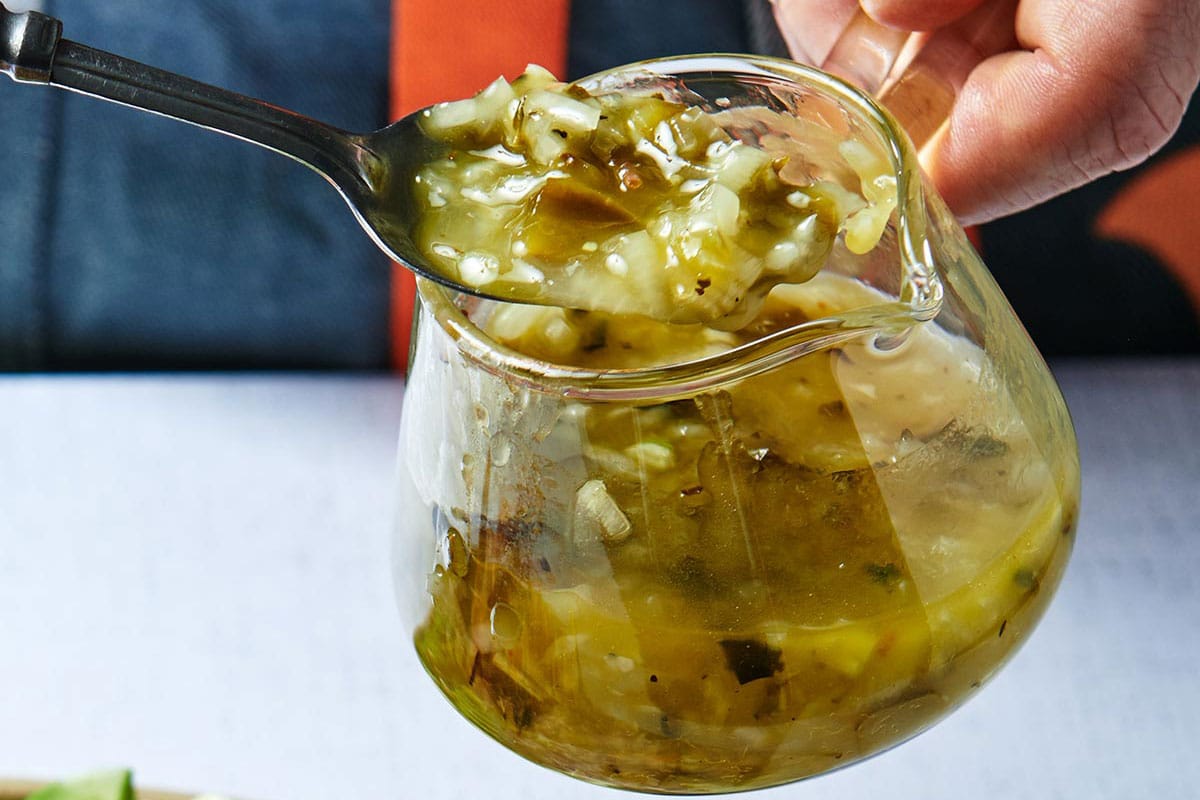 Lemon-dill dressing in small glass container.