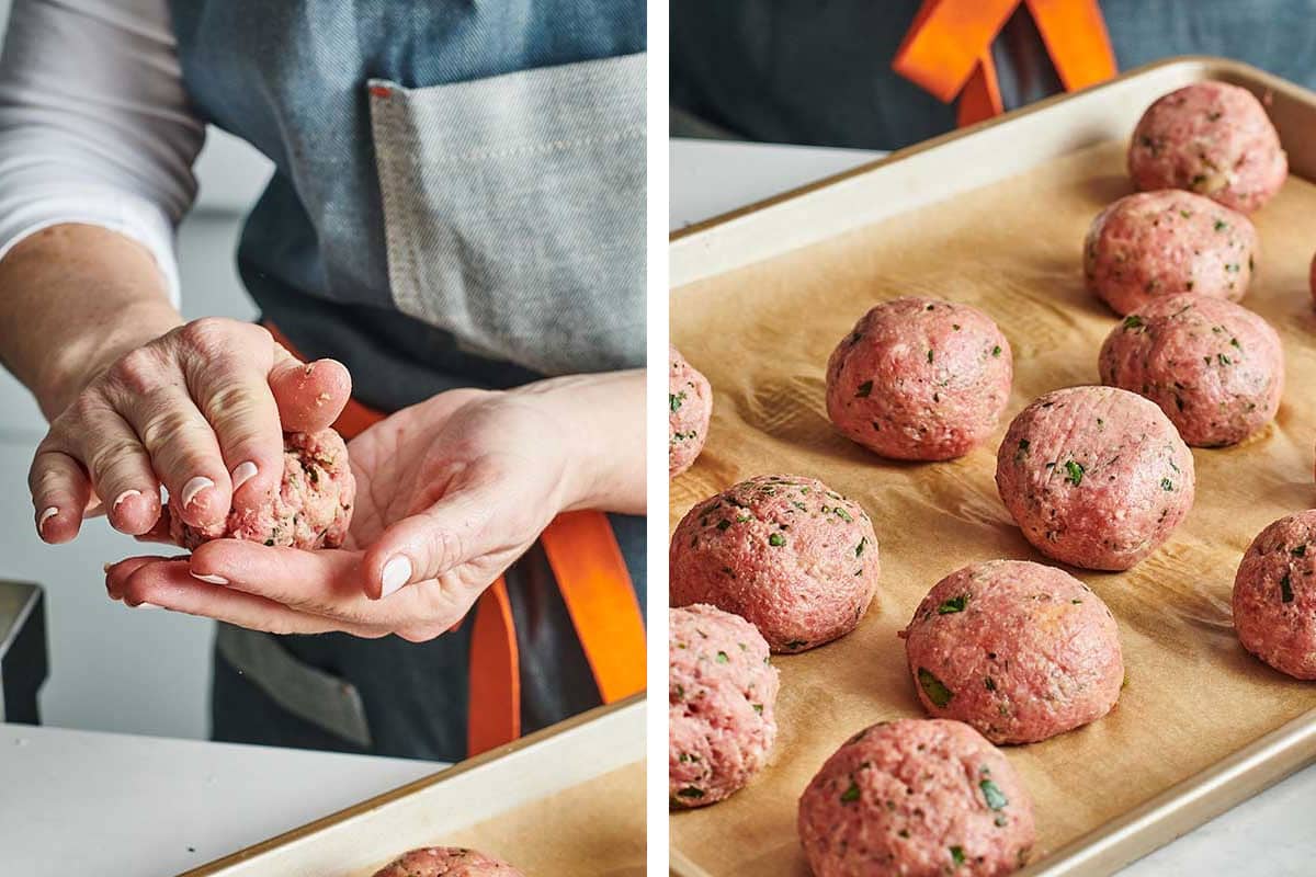 Katie Workman shaping giant meatballs and placing them on parchment-lined baking sheet.