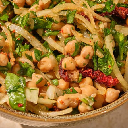 Brown bowl filled with Turkish Chickpea Salad.