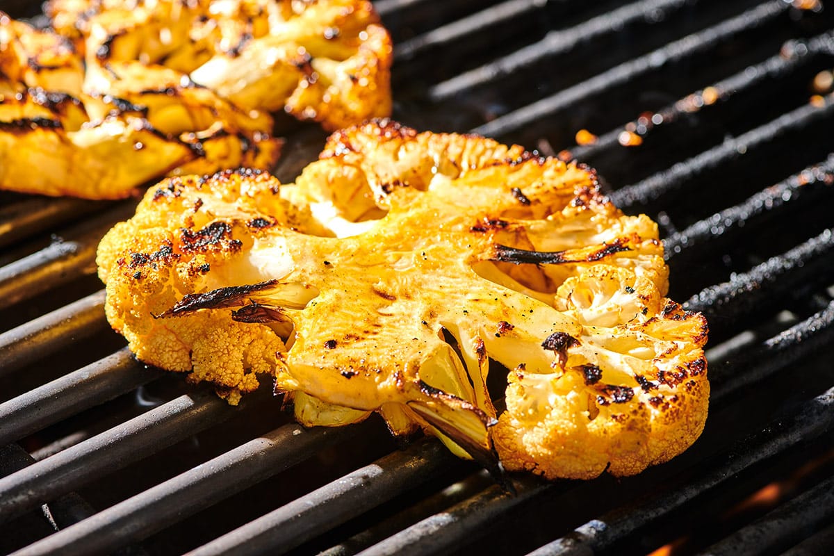 Cauliflower slices cooked on a hot grill.