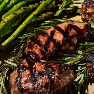 Grilled top sirloin steak and asparagus on serving platter.