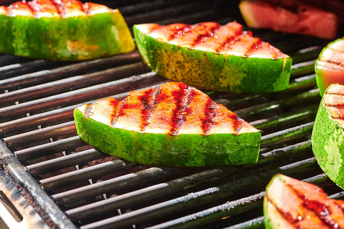 Watermelon wedges cooking on hot grill.