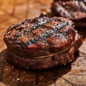 Grilled filet mignon on cutting board.