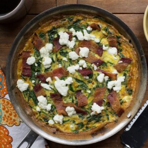 Pan with baked Frittata of goat cheese, spinach, and bacon lardons.