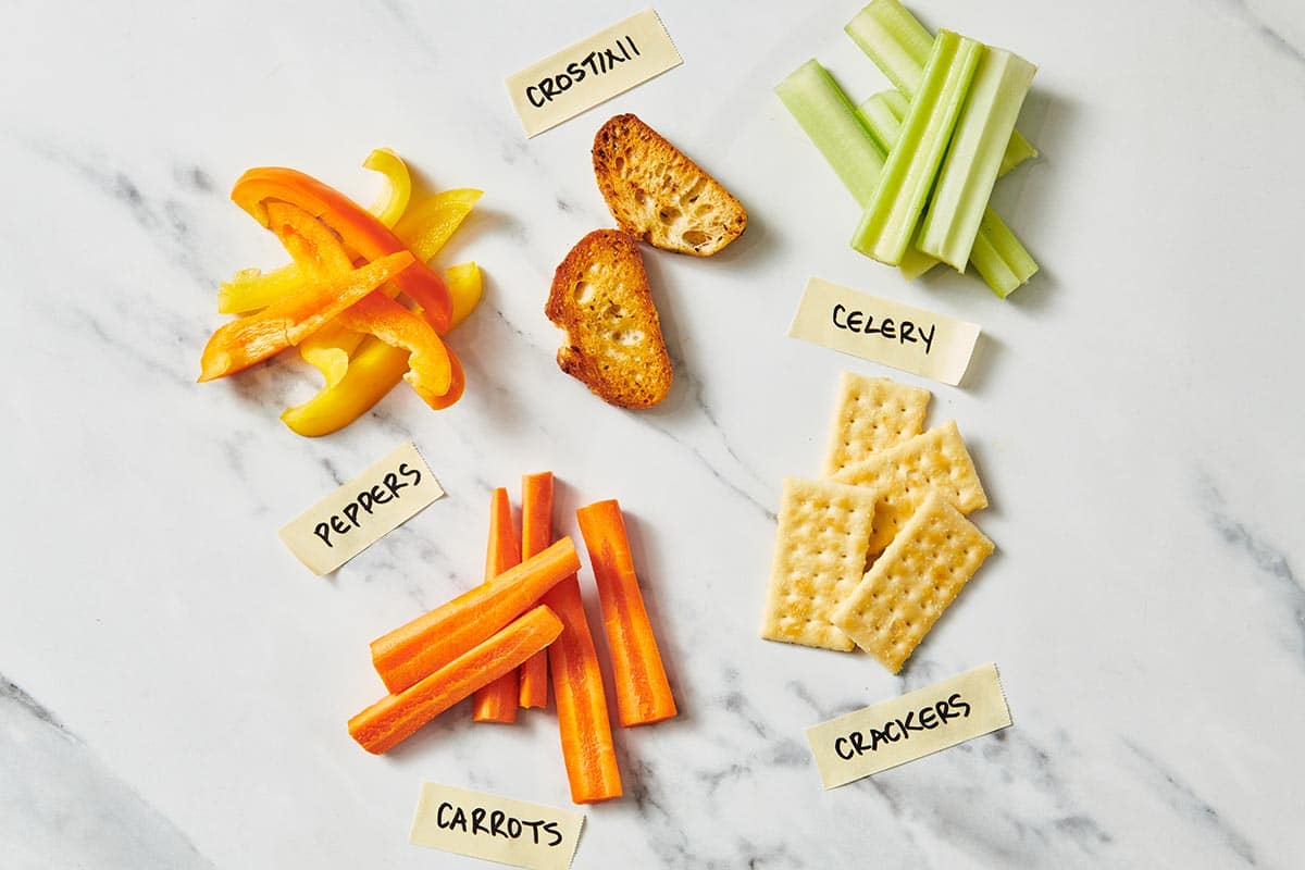 Carrots, celery, peppers, crackers, and pita chips for dips.