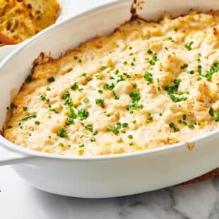 White dish with baked crab dip.