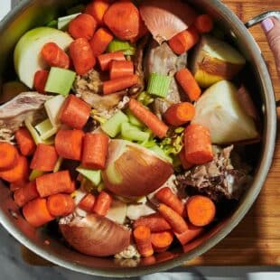 Turkey stock with carrots, onions, and bones in large stock pot.