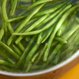 Blanching green beans in large pot of water.