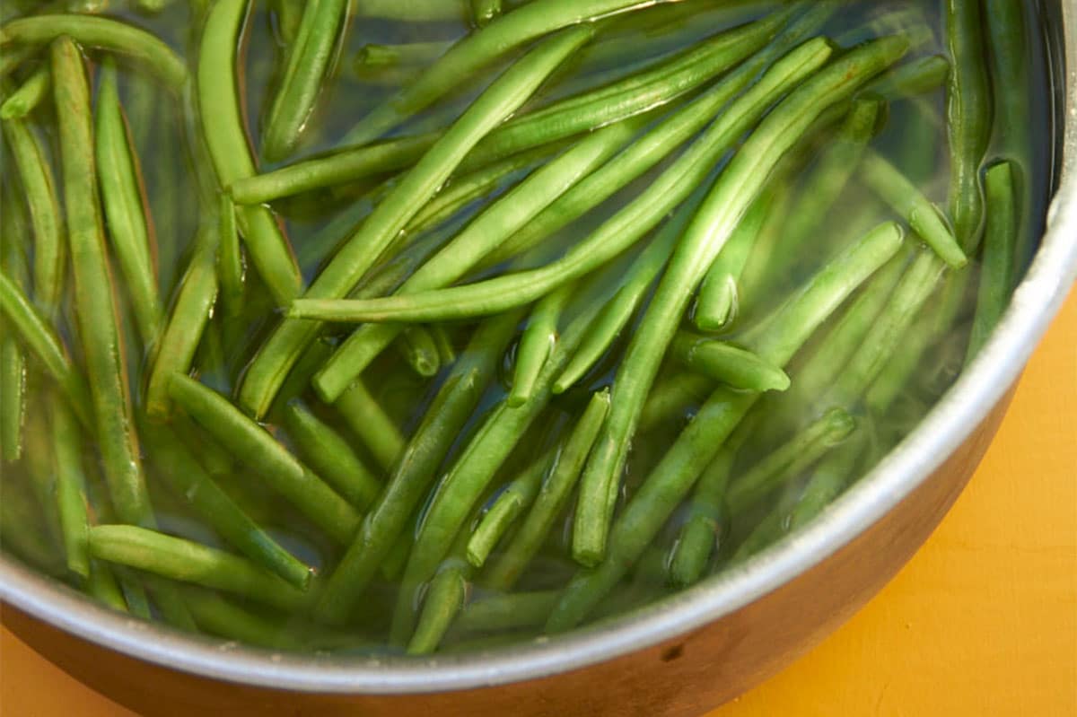 Blanching green beans in large pot of water.