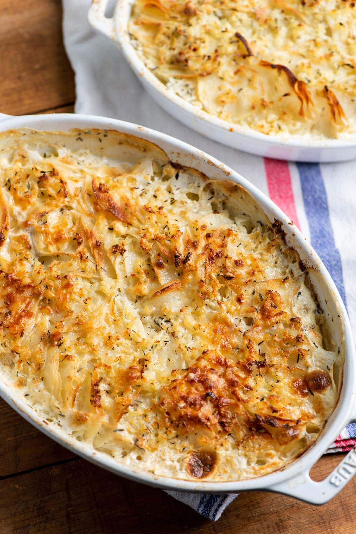 Creamy Scalloped Potatoes in white serving dish.