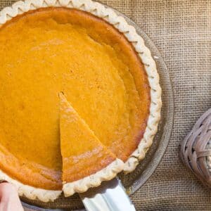 Cutting slice of Sweet Potato Pie from pan.