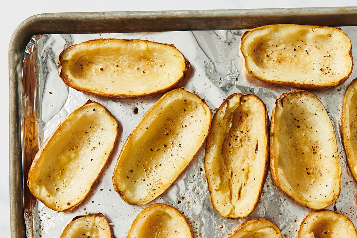 Seasoned potato skins on baking sheet.