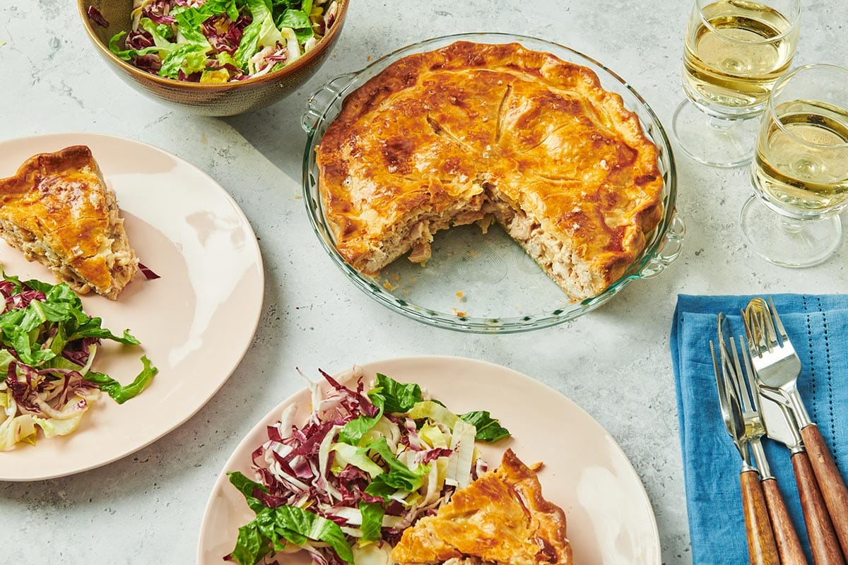 Moravian chicken pie in baking dish and on plate with salad.