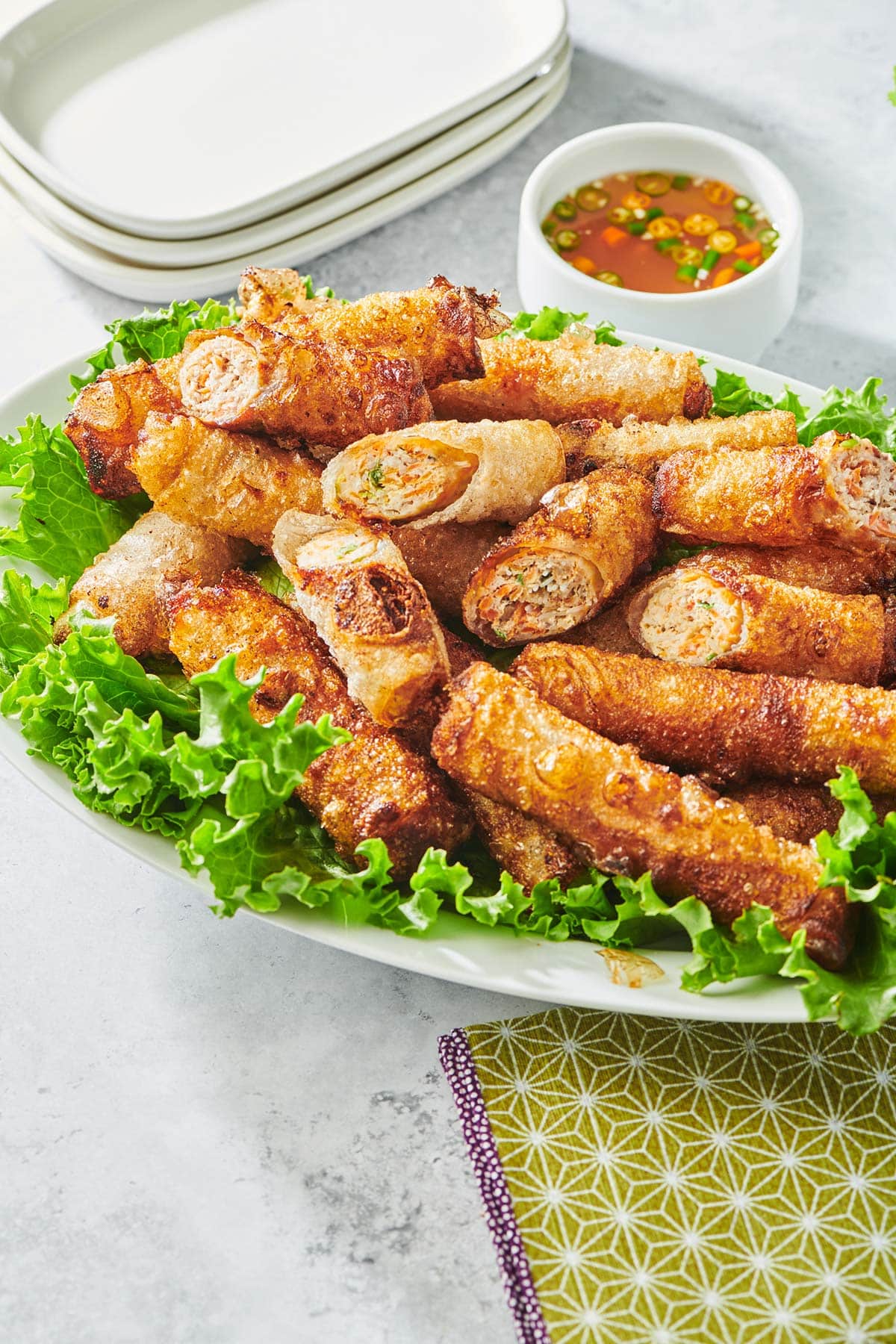 Platter of Vietnamese Spring Rolls on lettuce with dipping sauce.