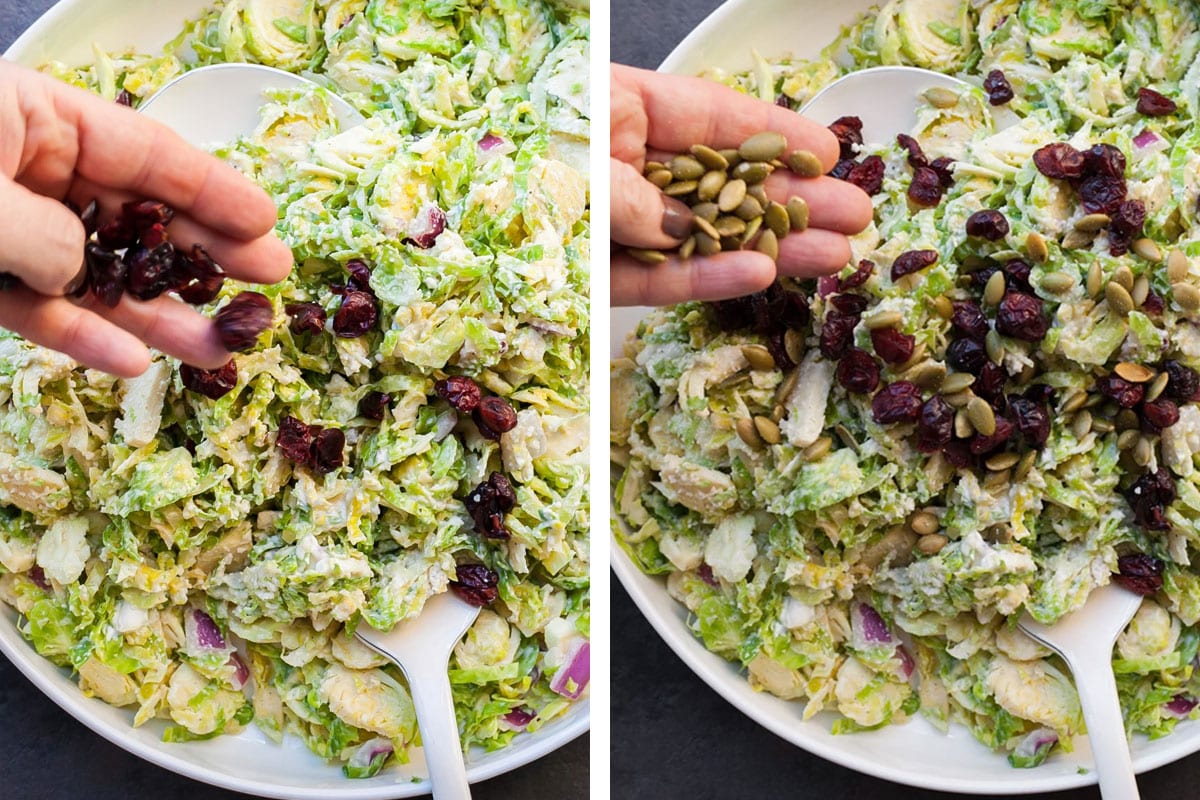 Woman sprinkles pepitas onto brussels sprouts slaw with dried cherries.