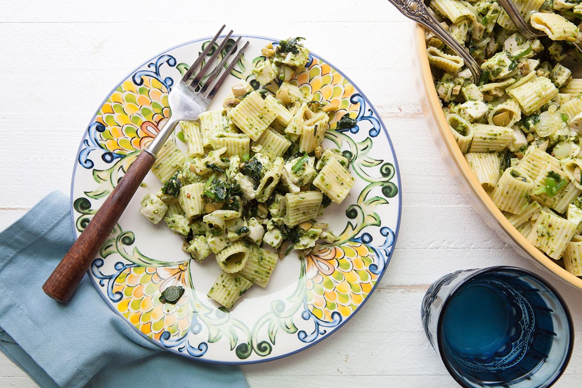 Chicken pasta salad with ramp vinaigrette on colorful plate.
