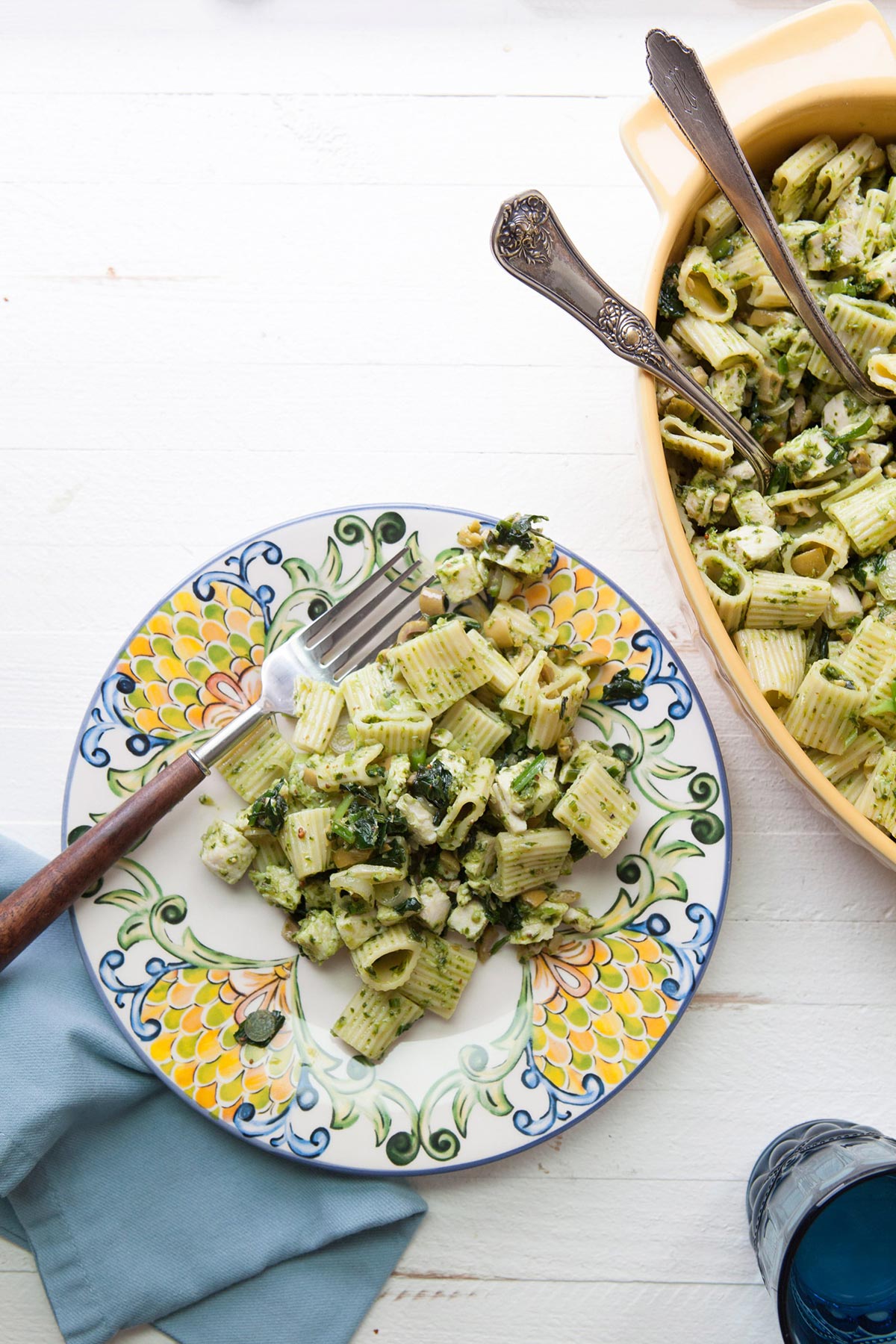 Pasta Salad with Chicken, Green Olives, & Ramp Vinaigrette in colorful bowls and plates.