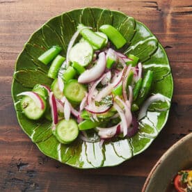 Sugar snap pea salad on green plate.