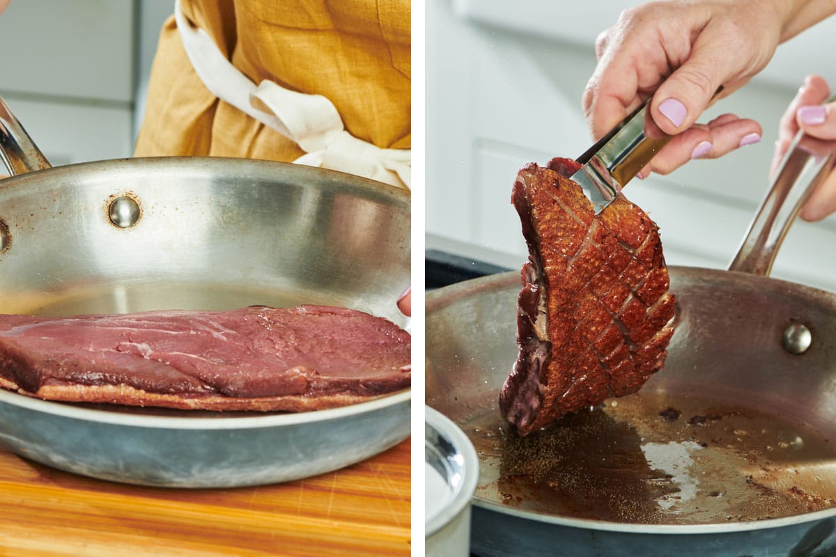 Cooking duck breast in pan on stove.