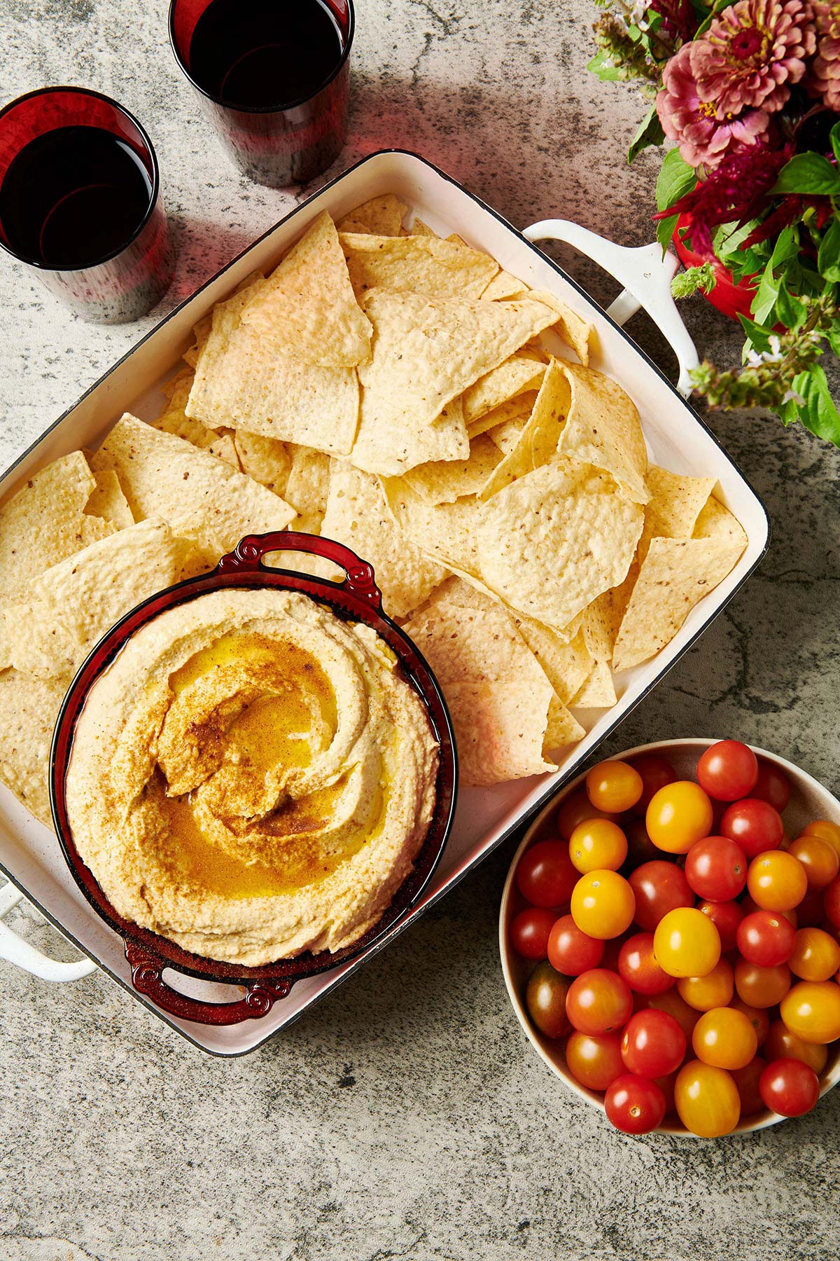 Bowl of hummus in a dish of chips.
