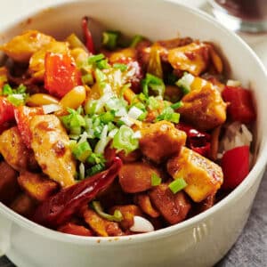Kung Pao Chicken in white bowl on table.