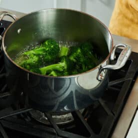 Steamed broccoli in pot on stove.