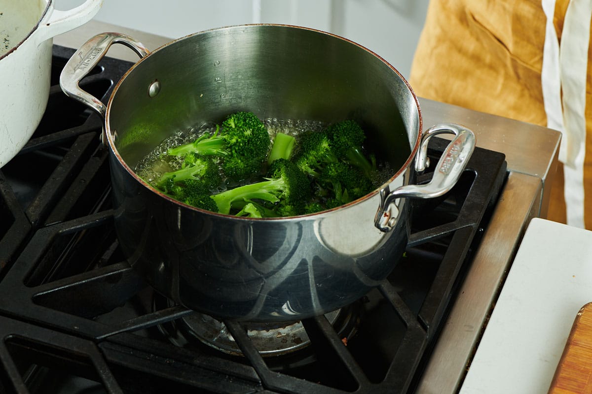 Steamed broccoli in pot on stove.