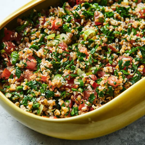 Yellow bowl filled with tabbouleh bulgur wheat salad.