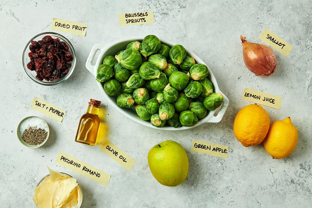 Brussel sprouts, apple, lemon, and other salad ingredients