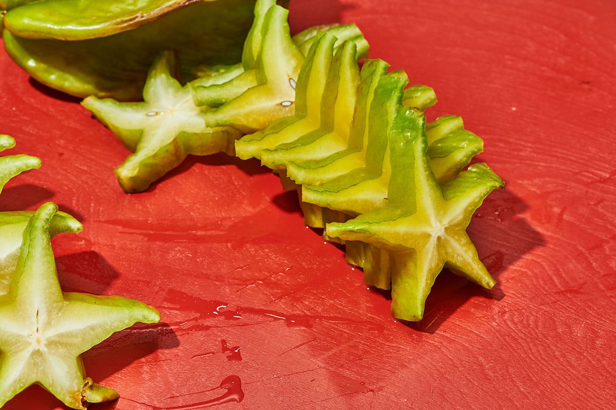 Stack of starfruit slices on table.