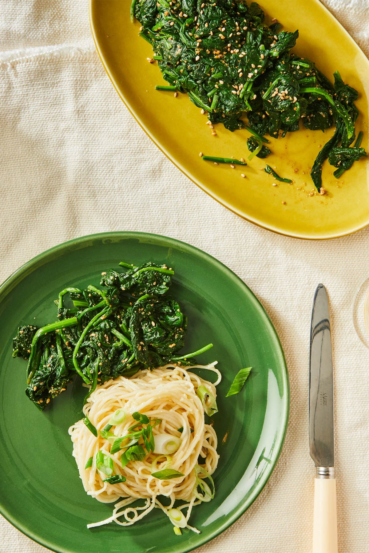Vietnamese garlic noodles and Japanese goma-ae on plates