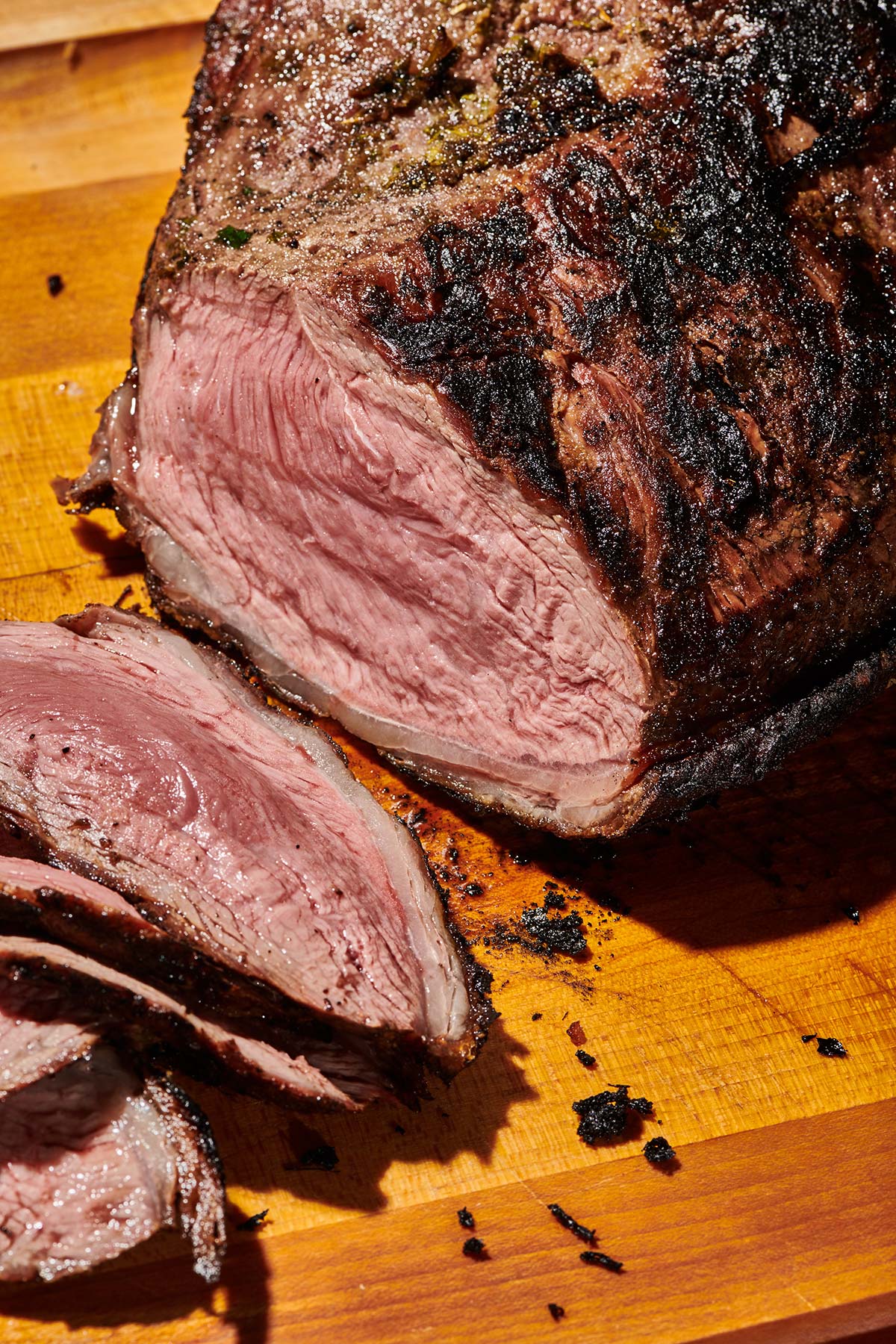 California-style grilled tri-tip steak partially slice on cutting board.
