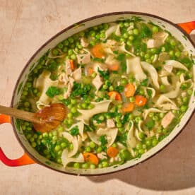 Leftover turkey soup in large bowl on table.
