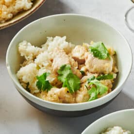 Stir-fried chicken and lemongrass with fresh cilantro in bowl on table.
