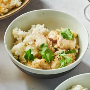 Stir-fried chicken and lemongrass with fresh cilantro in bowl on table.