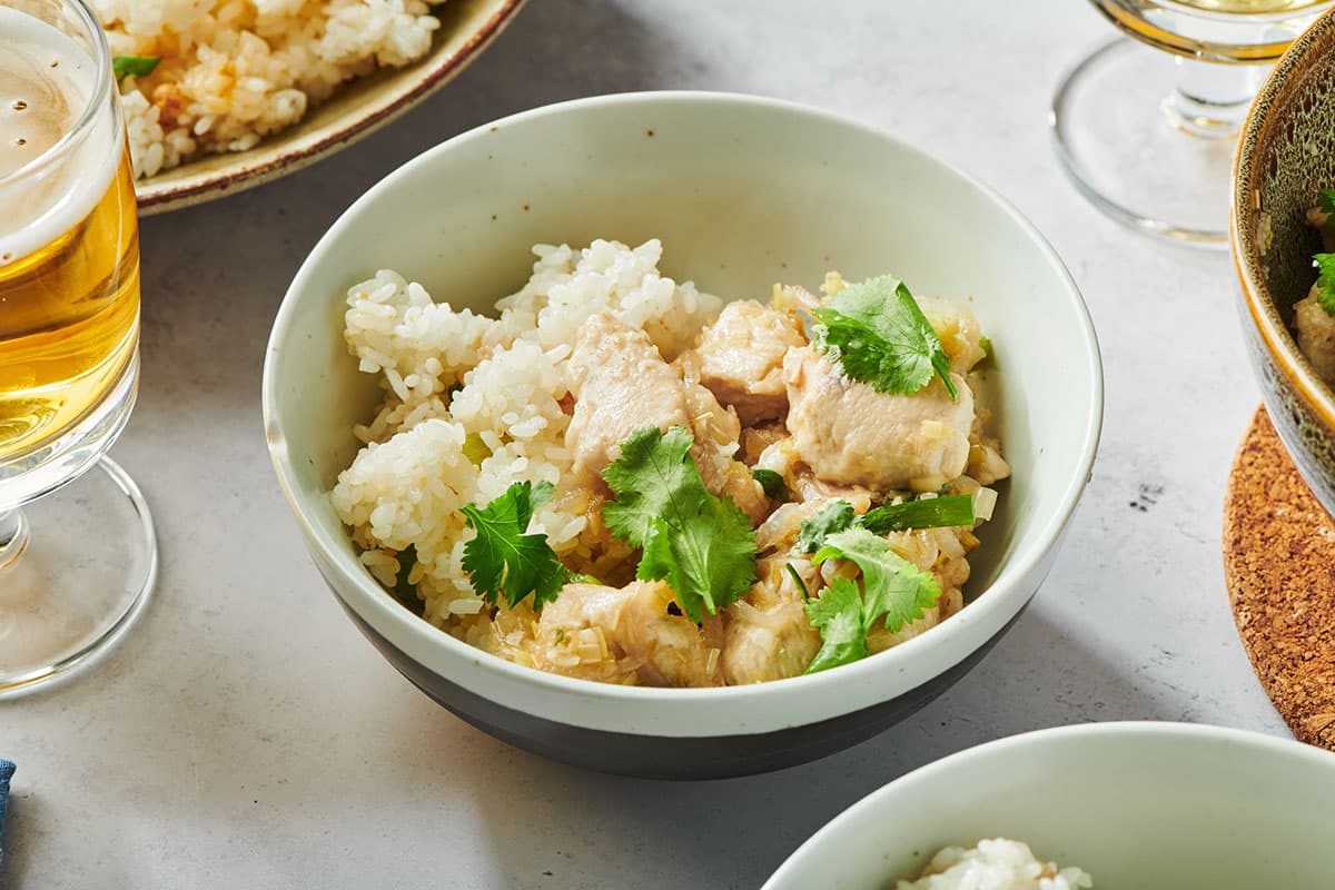 Stir-fried chicken and lemongrass with fresh cilantro in bowl on table.