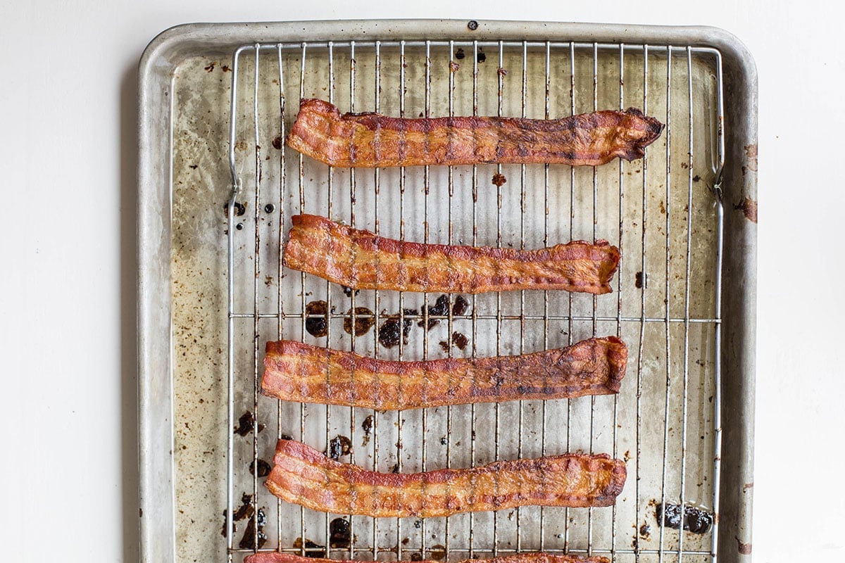 Cooked bacon on baking sheet with rack.