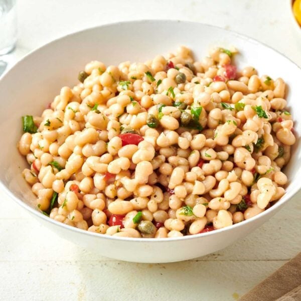White Bean Salad in white bowl on table.