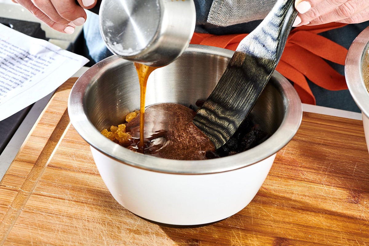 Pouring maple syrup into bowl for homemade granola.