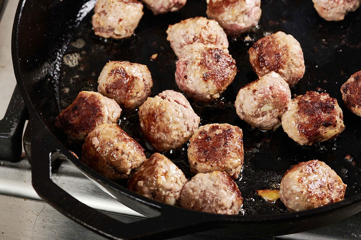 Meatballs in a skillet.